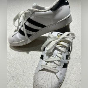 Old school Adidas Superstar shoes.